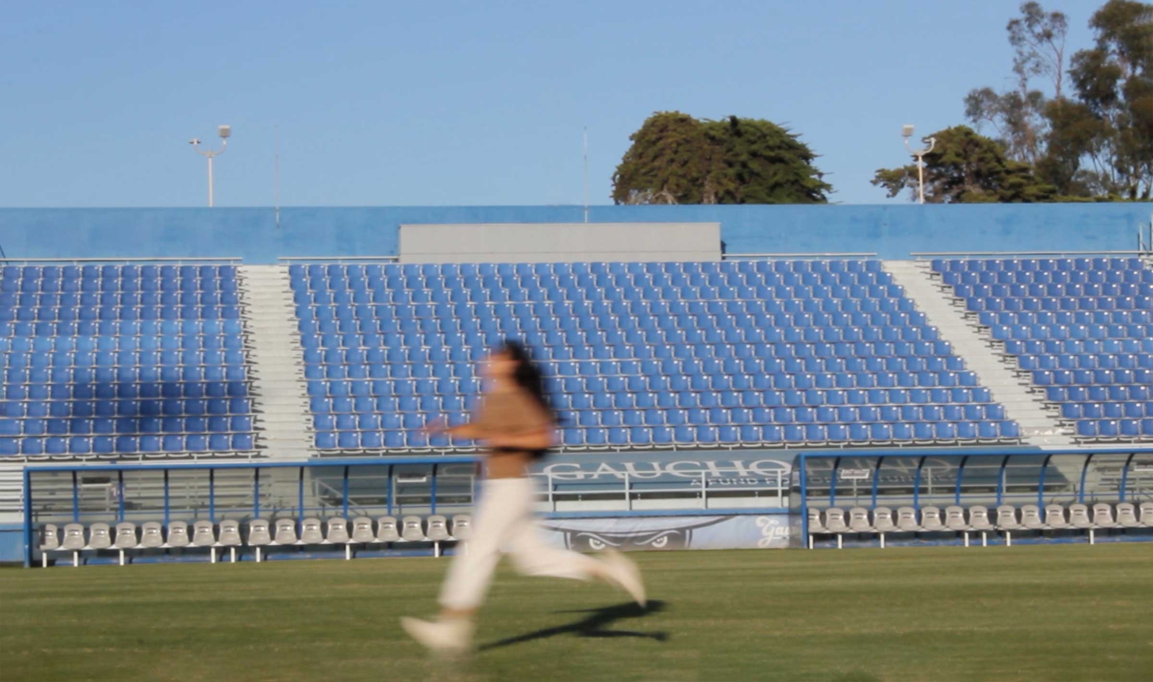 person running on stadium field