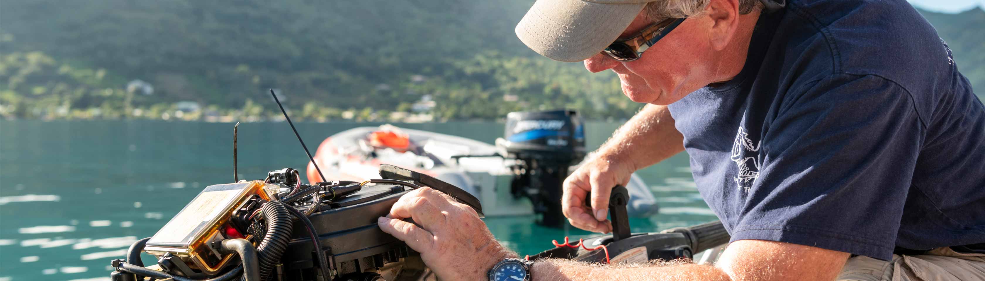 Russ Schmitt fixing a boat in the water