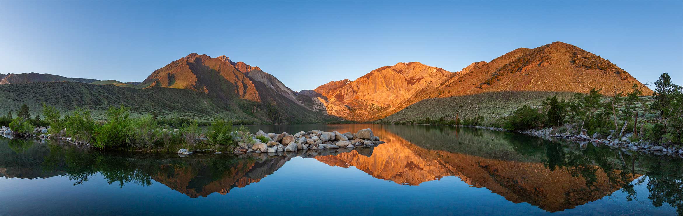 panoramic photo of Convict Lake with mountains reflecting in the water
