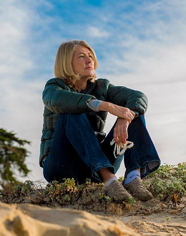 cris sandoval sitting on sand