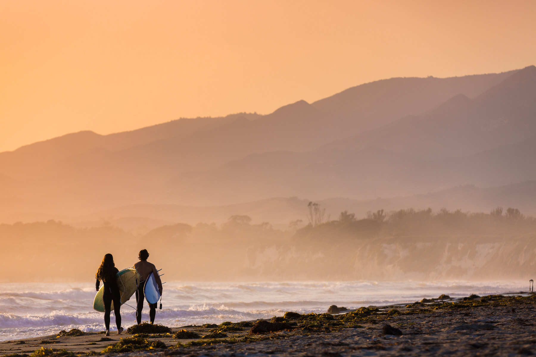 surfers at sunset