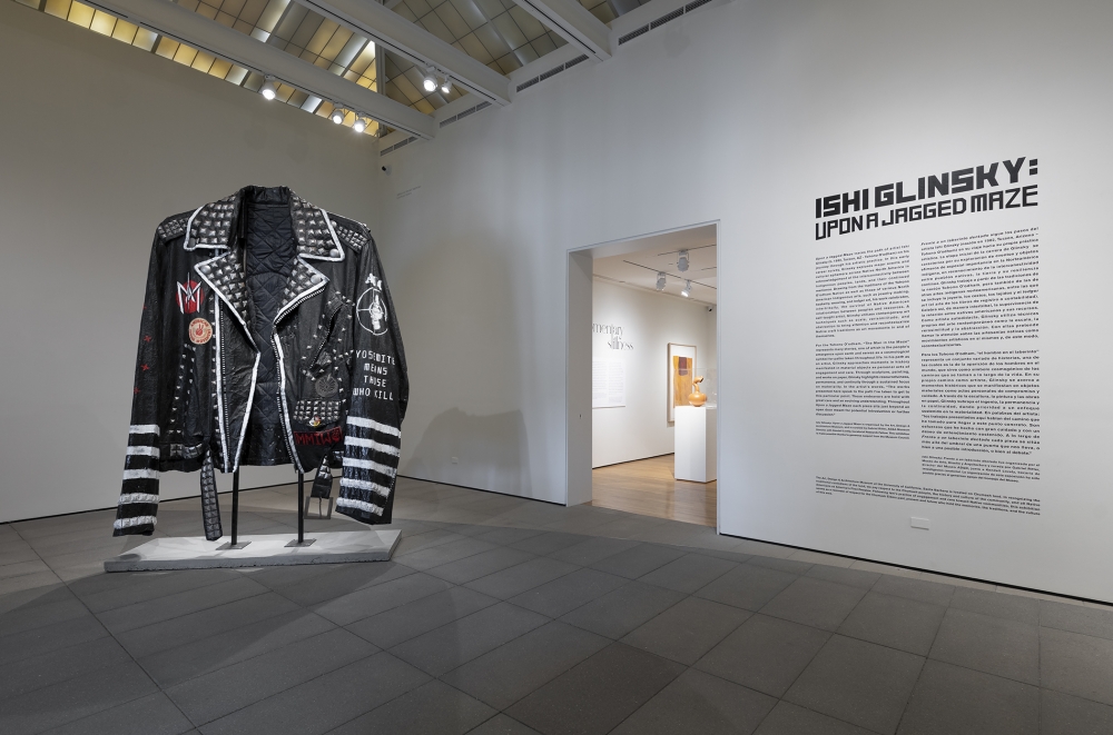 ten foot tall leather jacket on display in an art gallery
