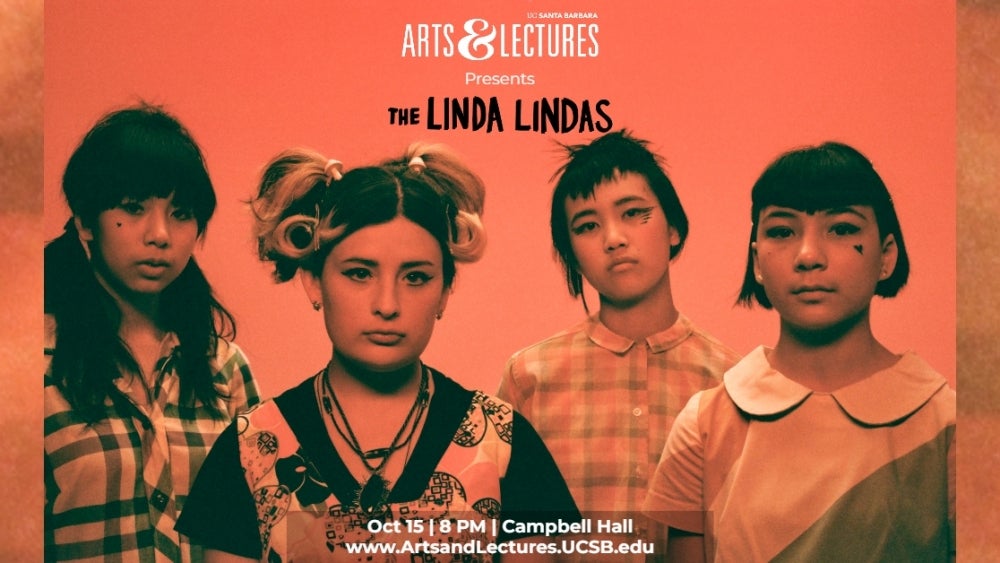 four young women with dark hair and red lighting looking at camera