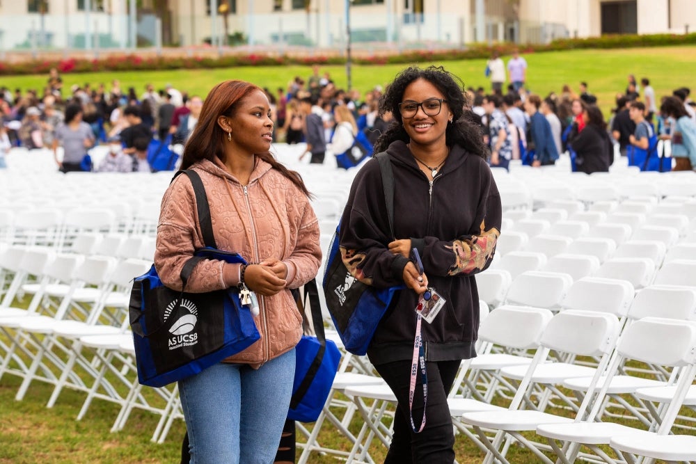 two students walking out of convocation