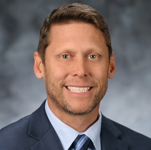 Shane Jimerson wears a blue suit and smiles