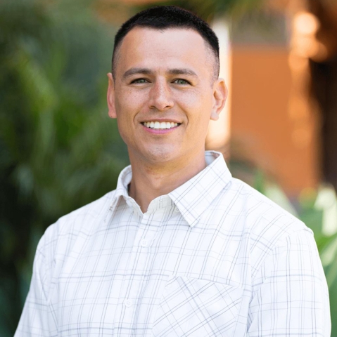 Daniel Oropeza wears a collared white shirt