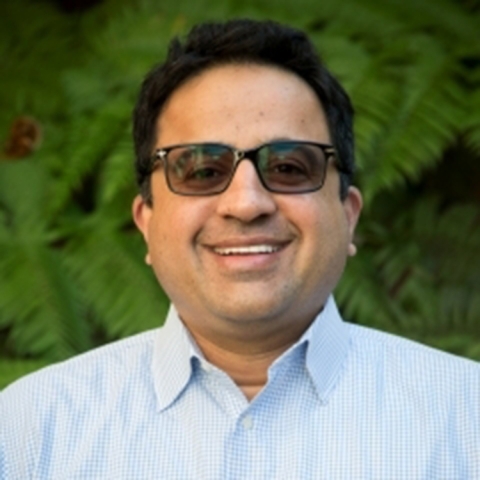 Ram Seshadri wears a light blue shirt and dark glasses