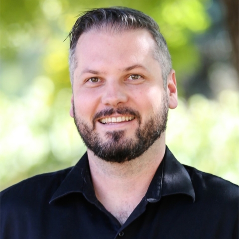 Michael Beyeler wears a black collared shirt