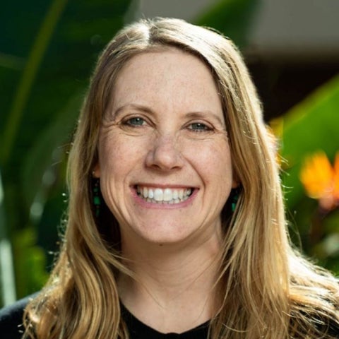 Elizbeth Ackert smiles outside in a black shirt