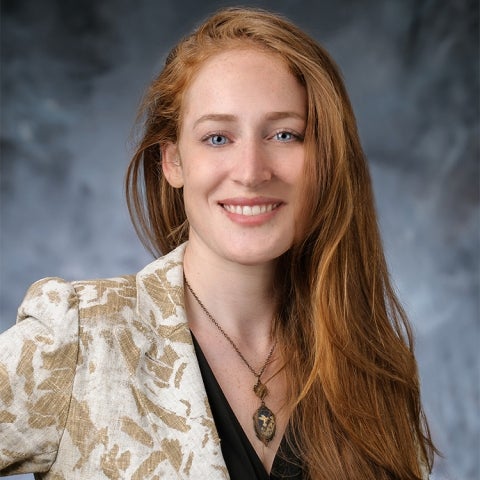 Andrea Carlini wears a patterned blazer