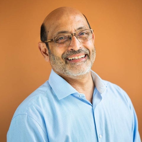 Umesh Mishra smiles, wearing a blue collared shirt