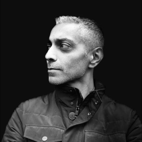 Amin Ghaziani wears a button-up coat in black & white