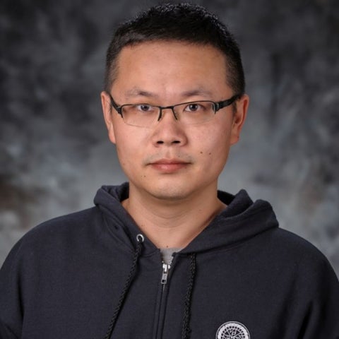 Gen Li wears a black hoody