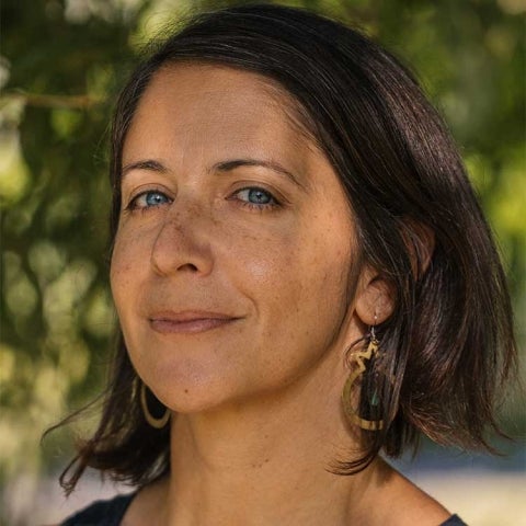 Mona Damluji stands under a tree