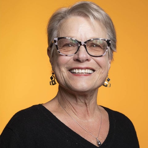 Brenda Major wears a black top and eyeglasses