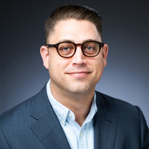 Jim Casey wears a dark suit