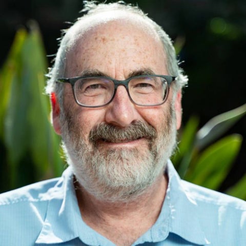 David Siegel wears a blue collared shirt and glasses