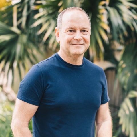 Casey O'Hara stands outside in a blue shirt