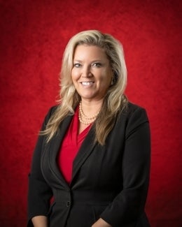 Ann Musto in red blouse and black jacket