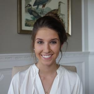 Woman dressed in white in front of a mantle