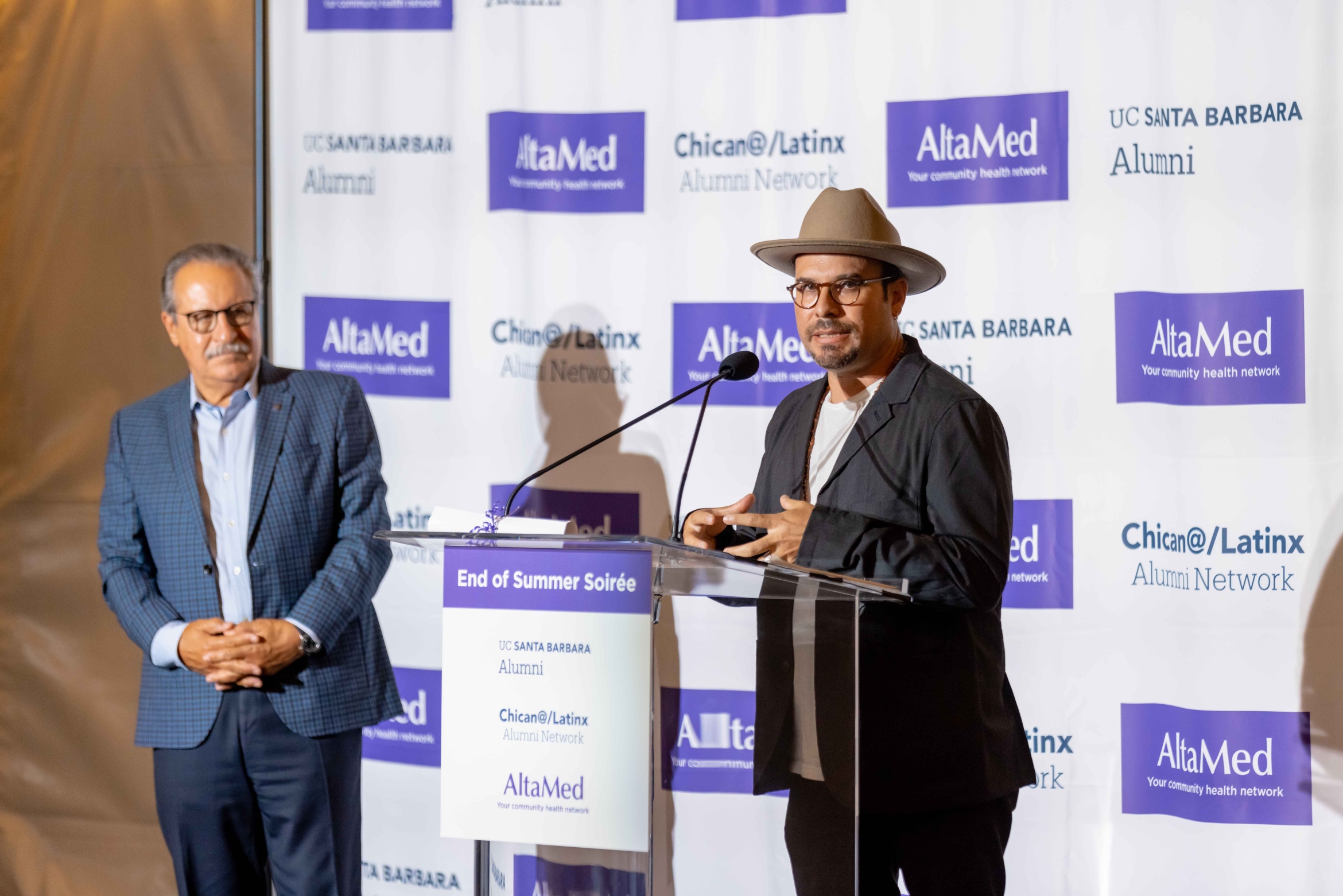 Michael de la Rocha, front, speaks during an event celebrating the scholarship, as Cástulo de la Rocha looks on