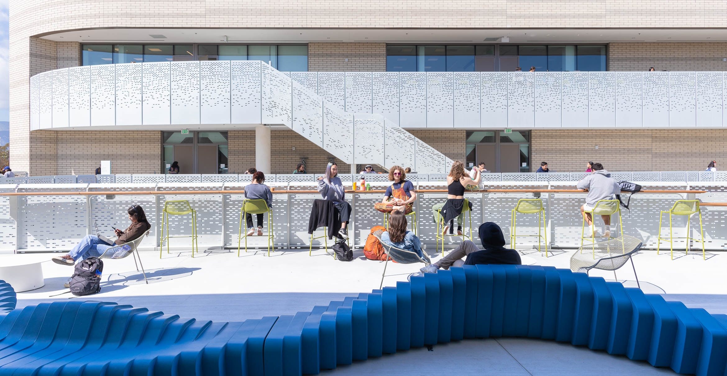 Students study and lounge on the balcony.