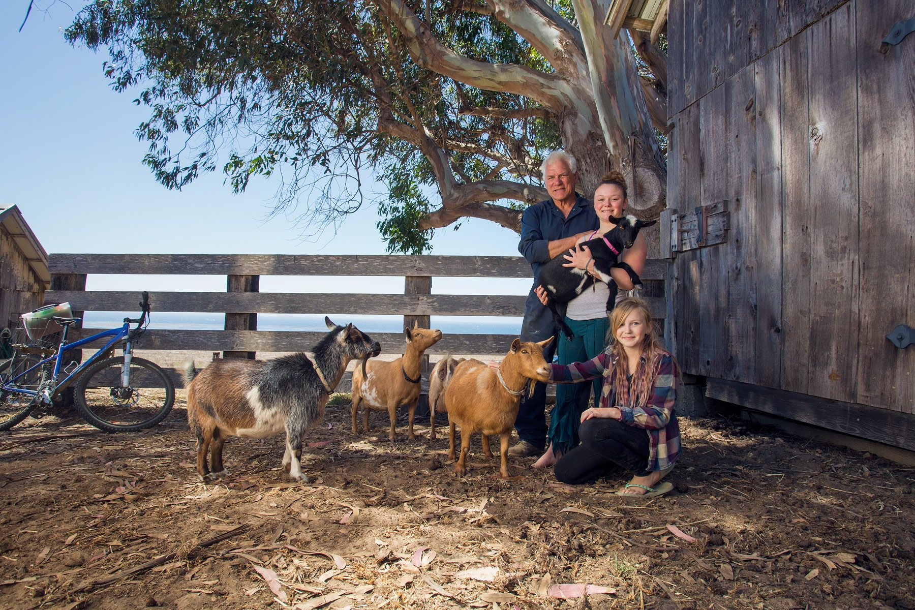 Director Don Canestro with daughters Carla, 13, and Stella, 11, and their pet goats, outside the barn near their home on KSN Norris Rancho Marino Reserve.