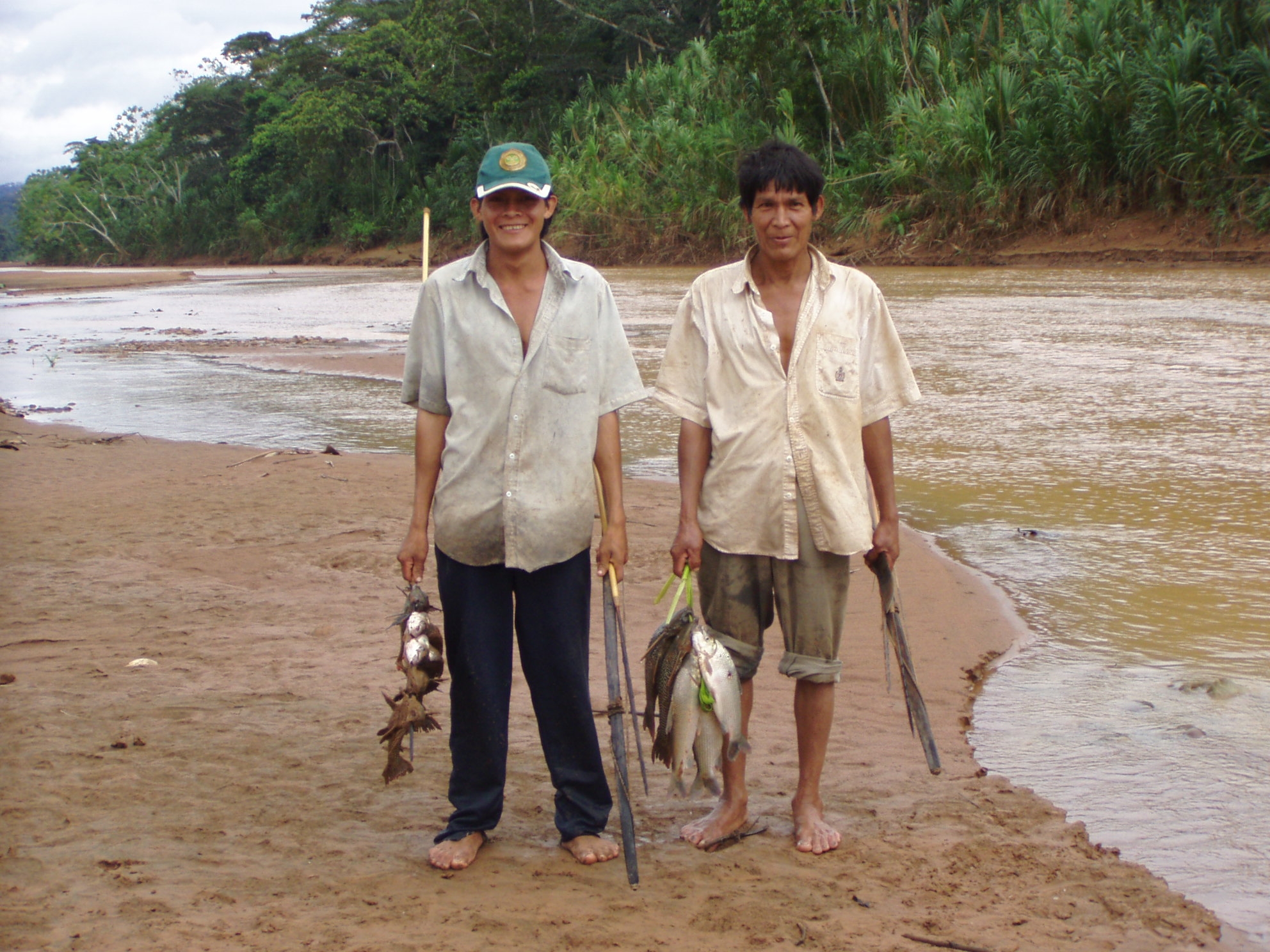 Two Tsimané tribesmen with fish