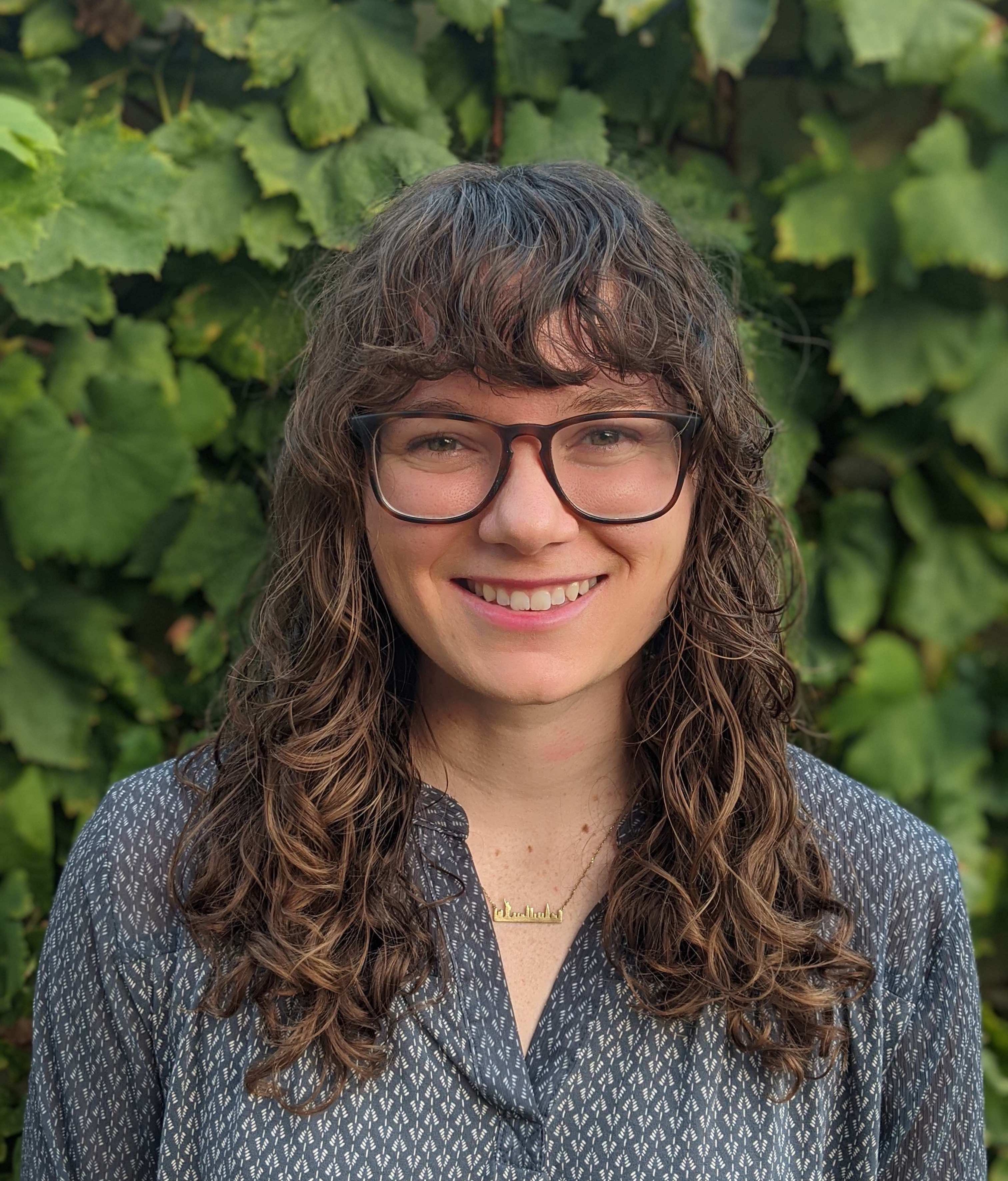 Amelia Ritger in a gray top with glasses.