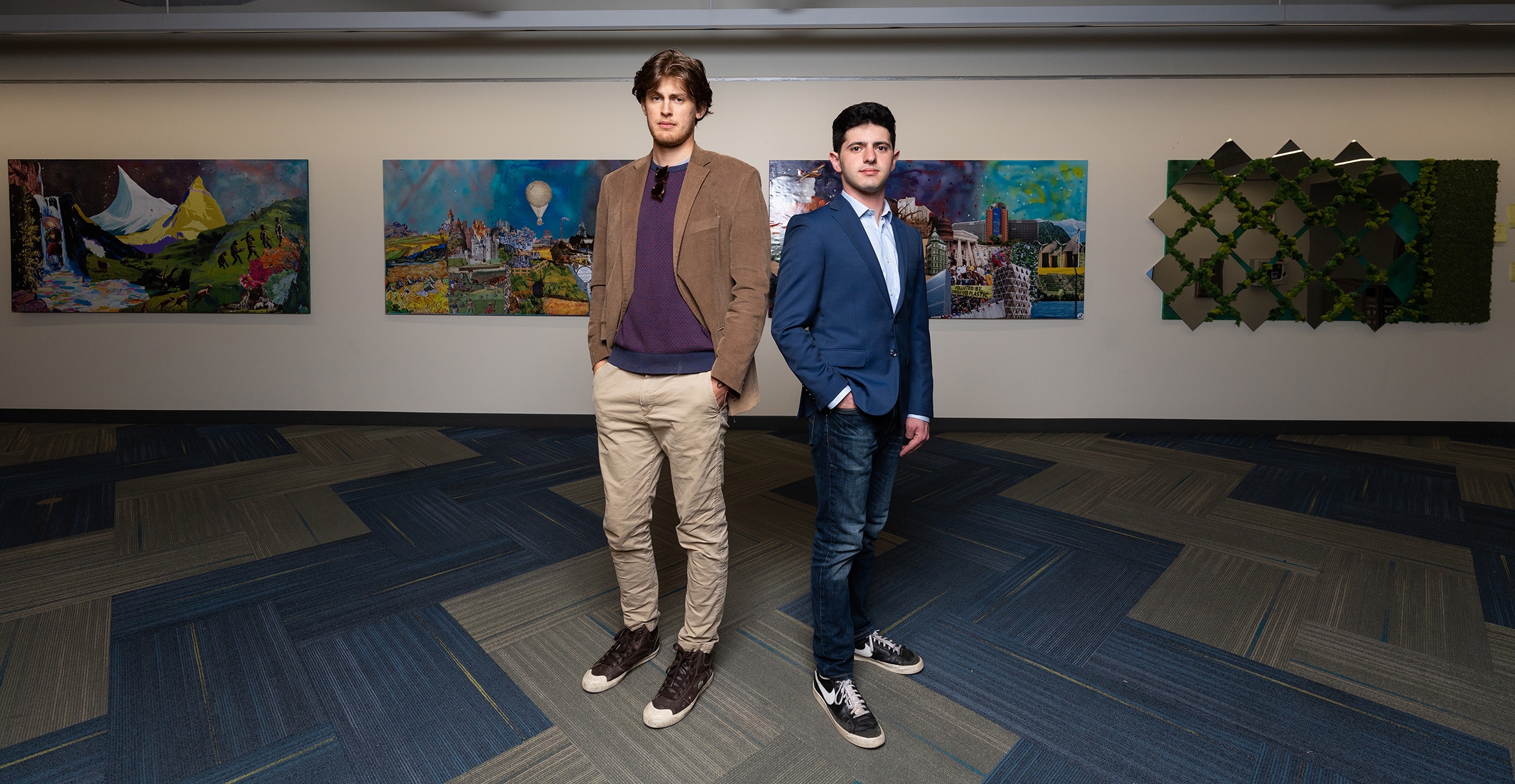 Lukas Kraak and Noah Weiss stand with their art piece "Anthroterra"