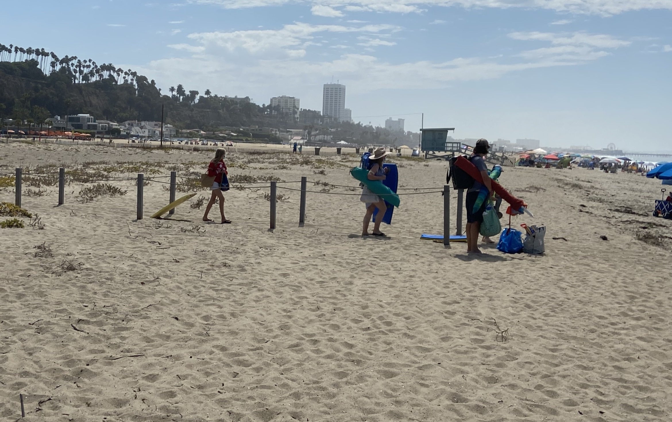 Beachgoers walking through the project site