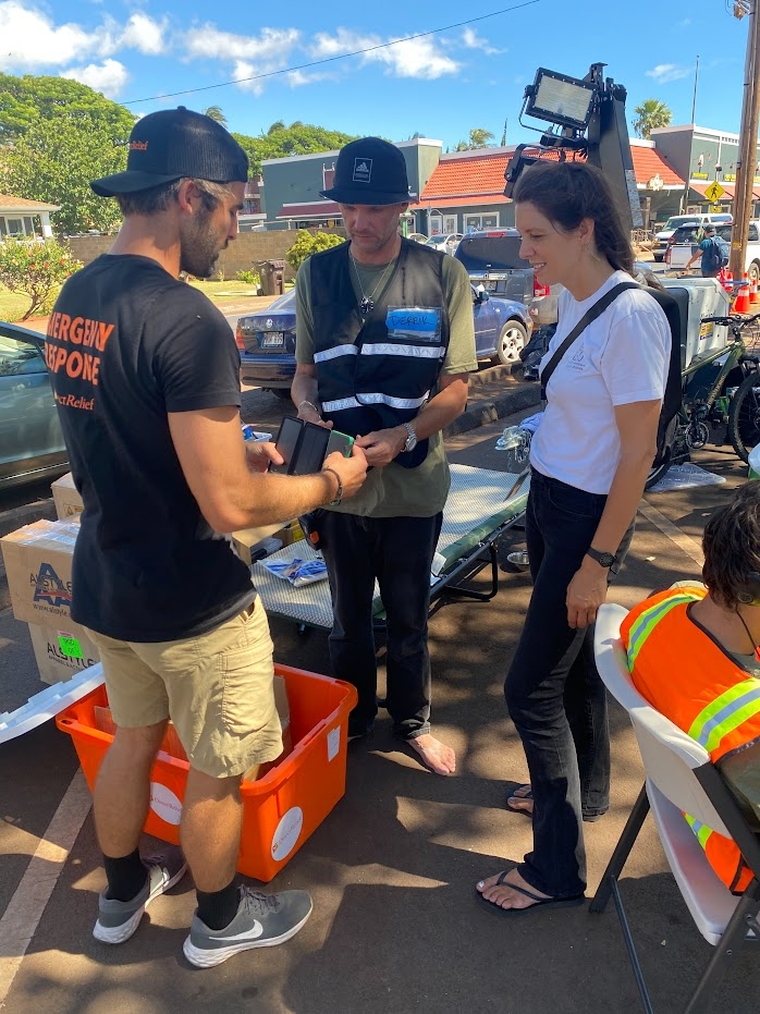 emergency responder handing out solar charger