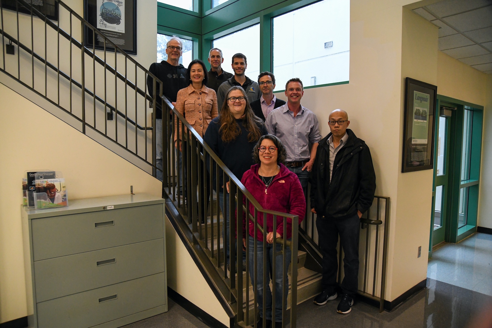 group of researchers standing on stairs