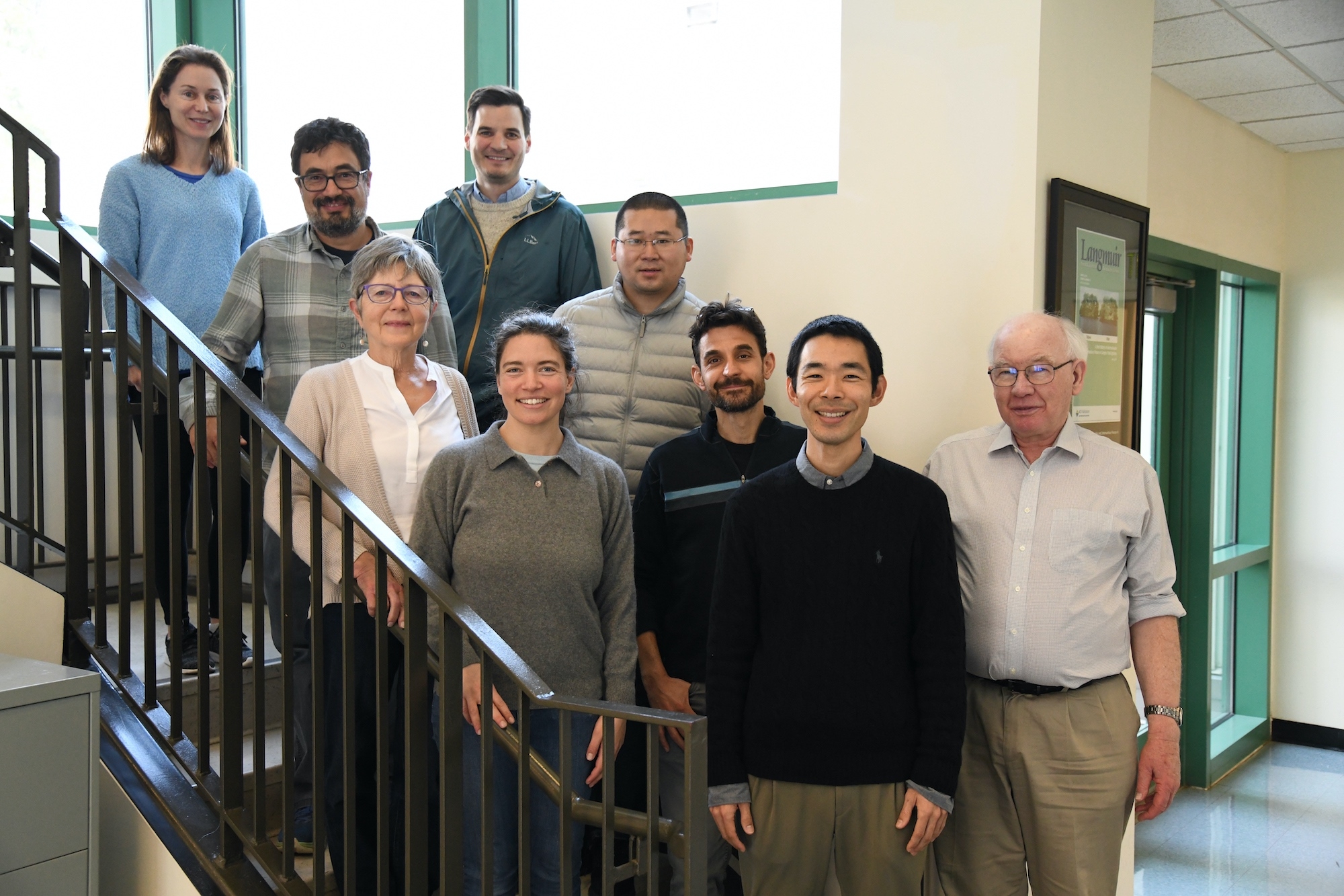 group of researchers standing on stairs