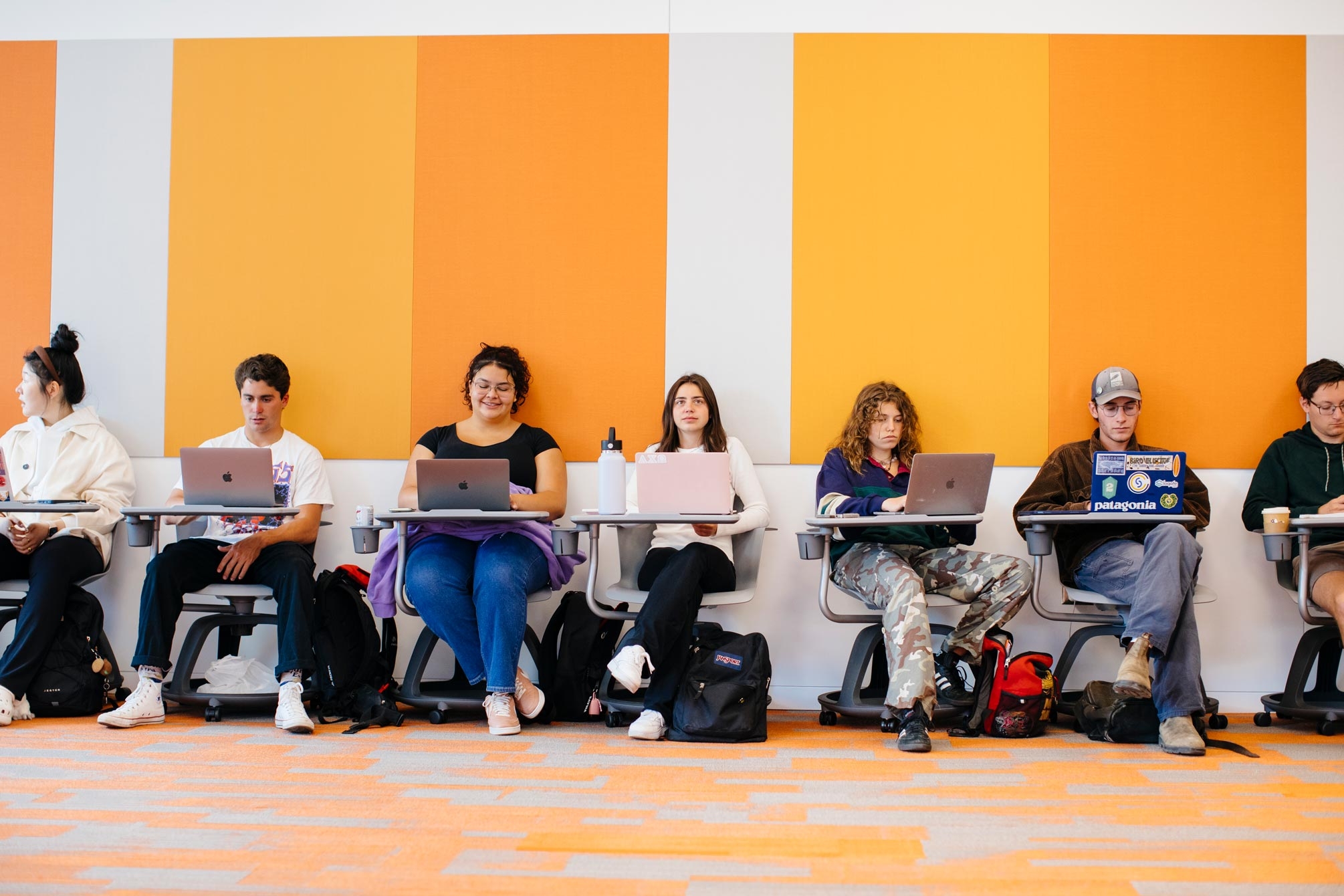 students at desks with laptops 