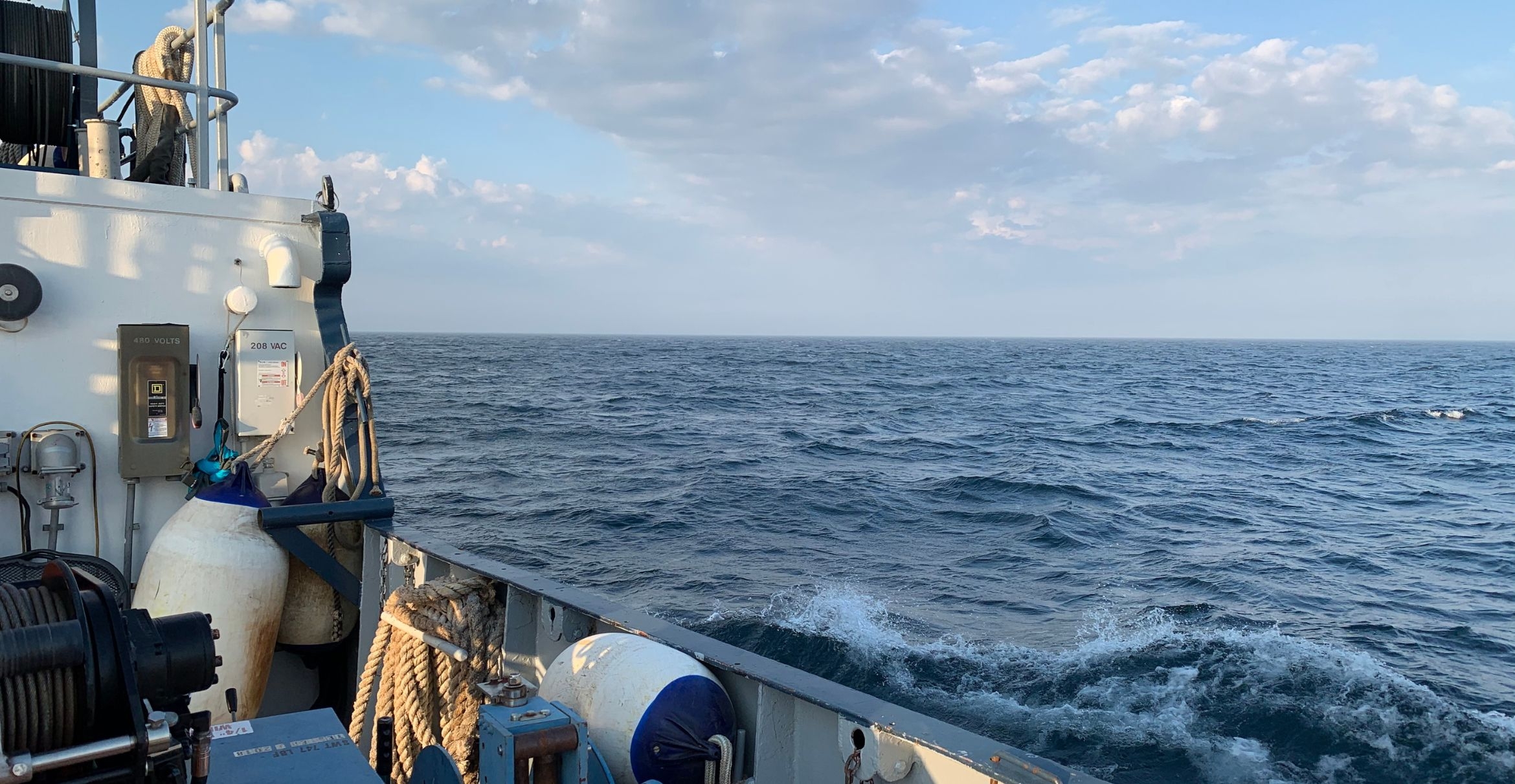 The surface of Lake Superior from the back of a research vessel.