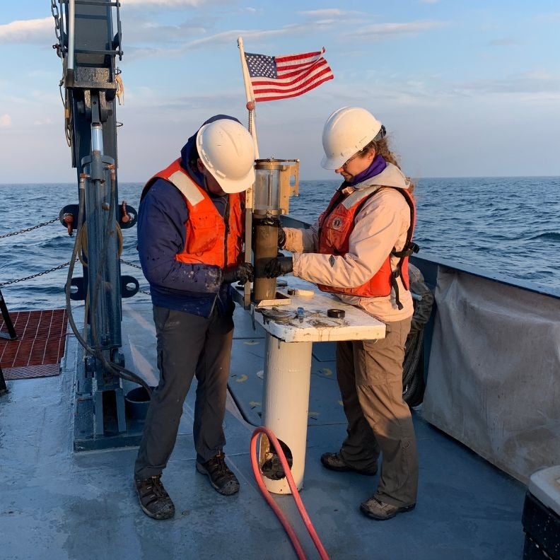 Researchers extract a sediment sample taken from the bottom of Lake Superior.