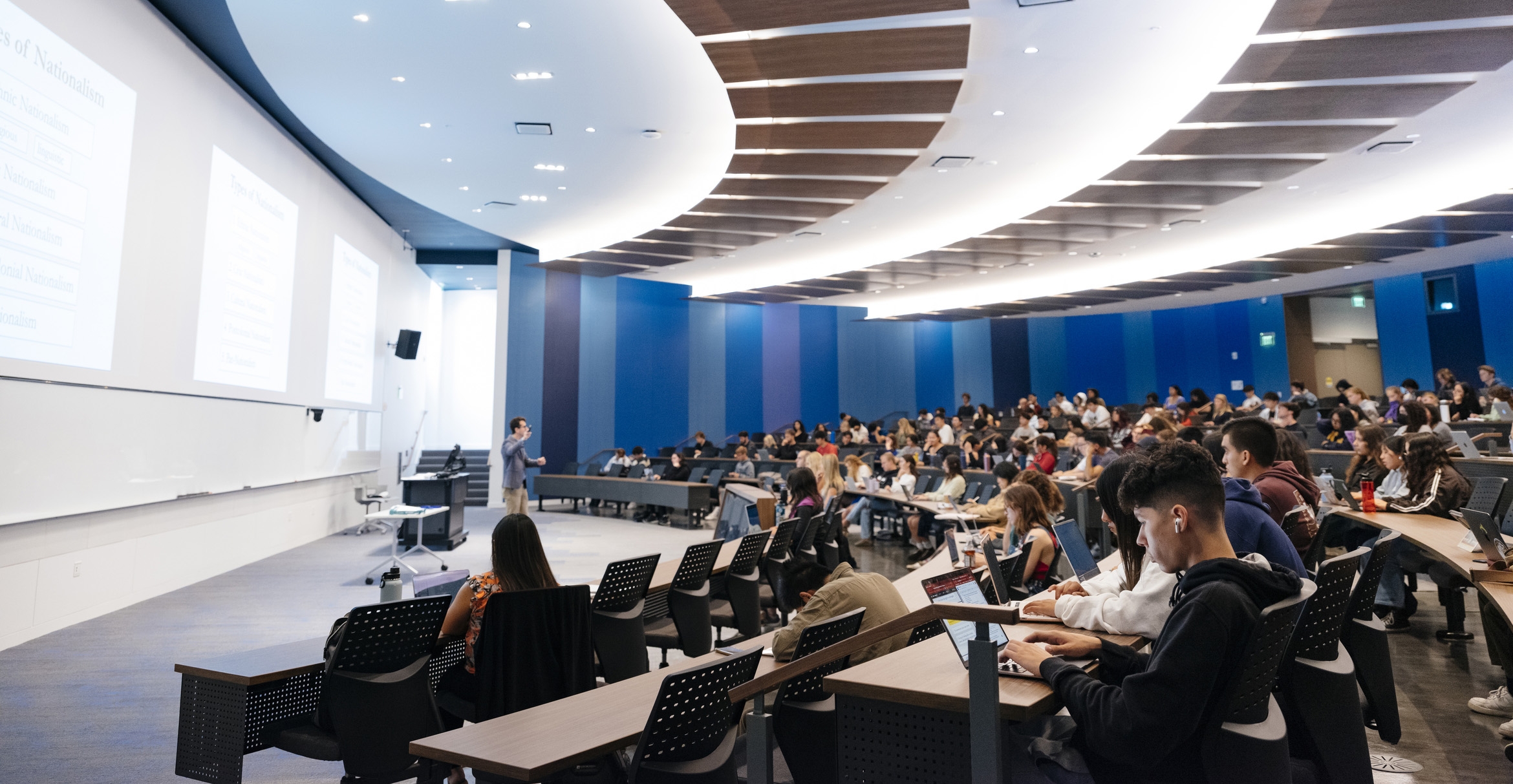 Diverse group of students listening to a lecture in a modern lecture hall