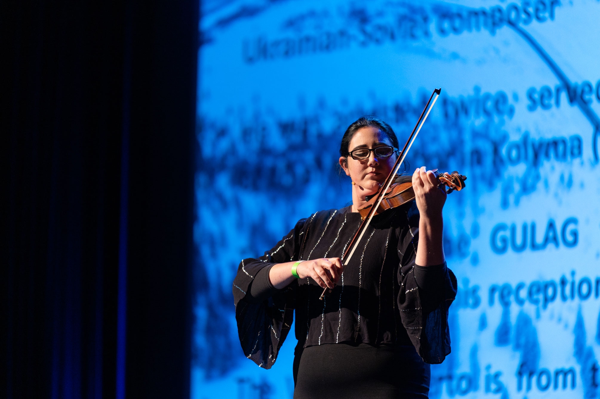 woman plays violin on stage
