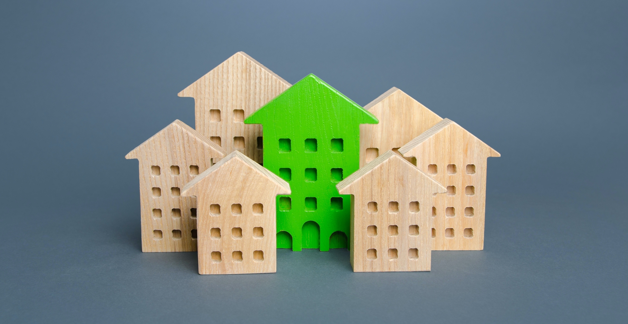 concept photo of a green building amid regular buildings