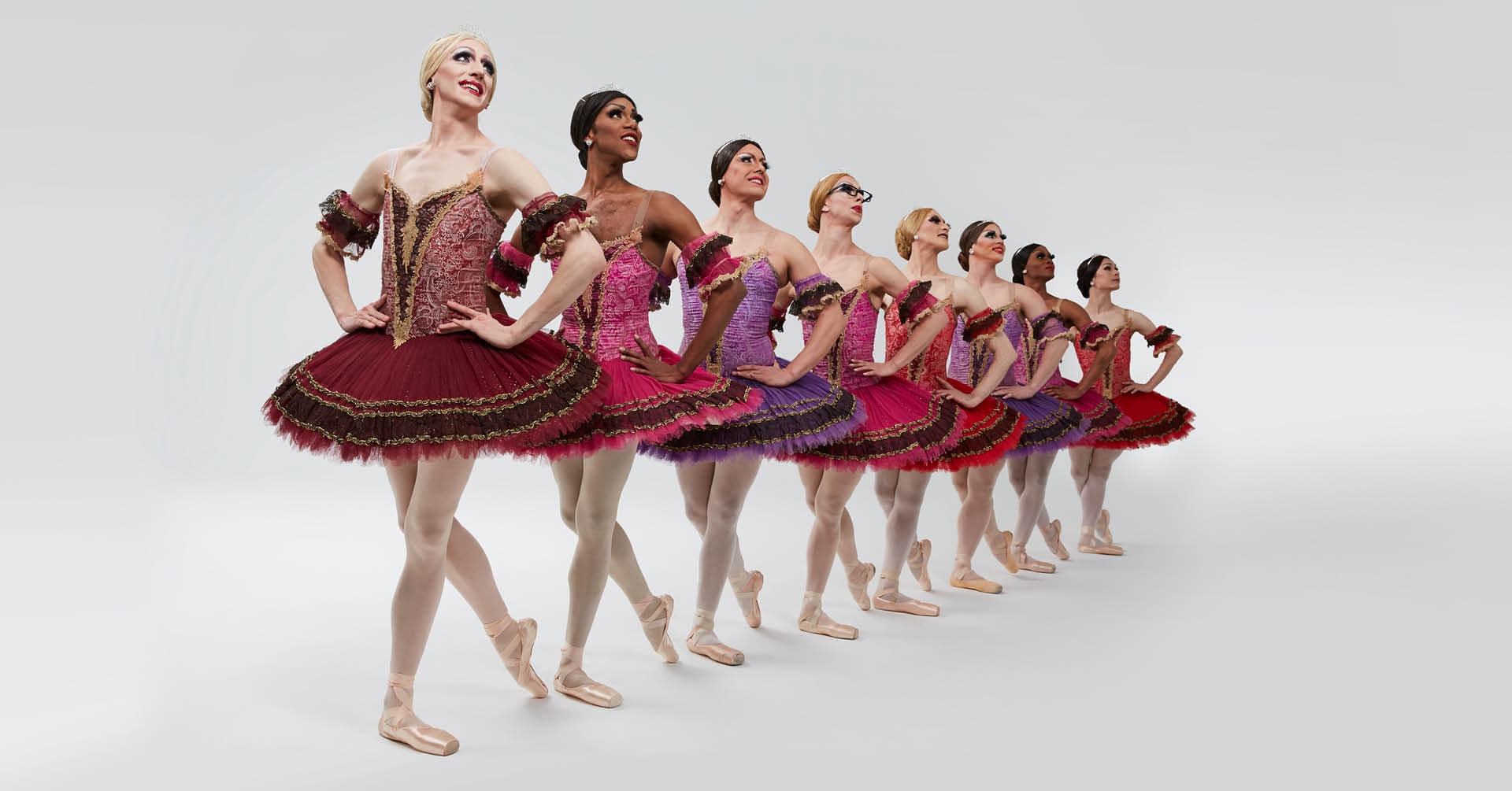 Dancers from Les Ballets Trockadero de Monte Carlo posed in red dresses