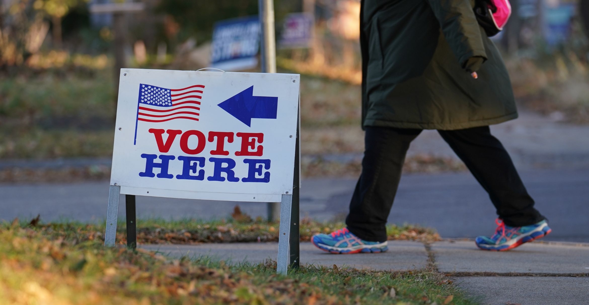A person walks past a Vote Here sign in Minneapolis, Minnesota.