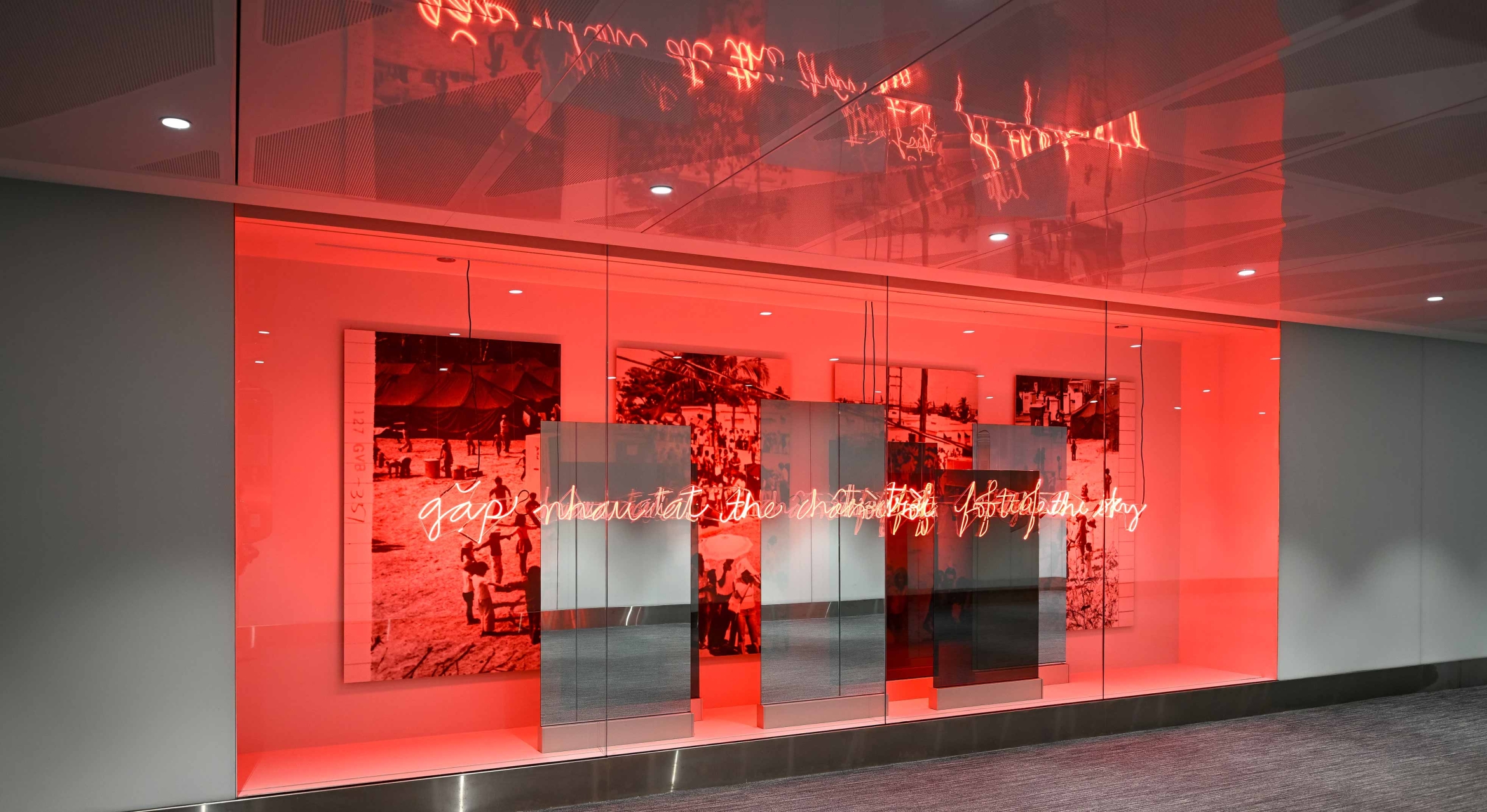 red neon lights a window box in grey hallway with photo panels and mirrors