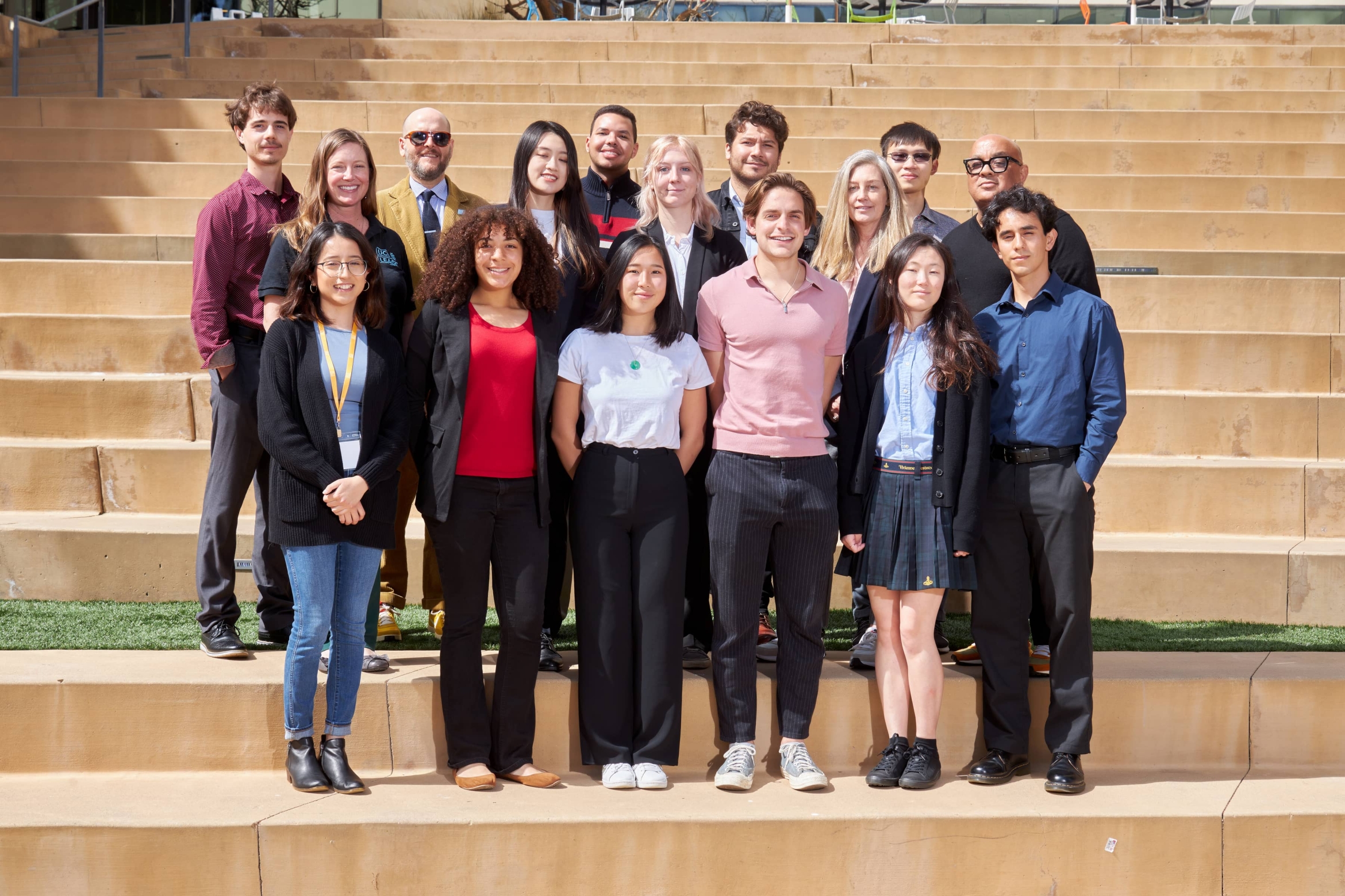 two rows of students and mentors on stone steps