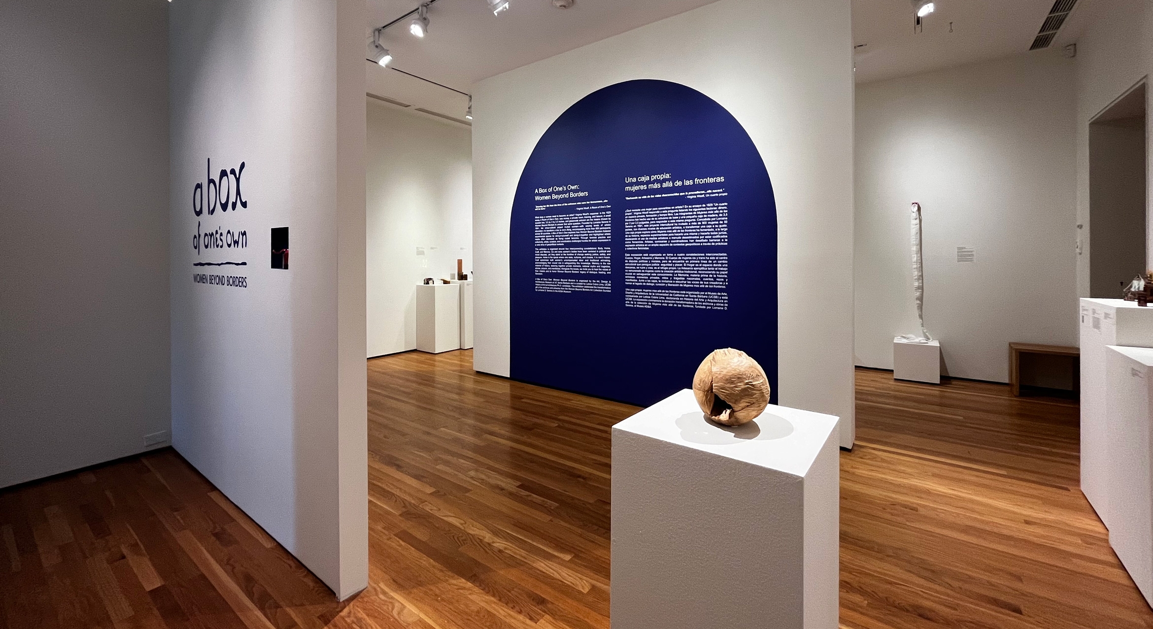 installation view in gallery with blue arc panel