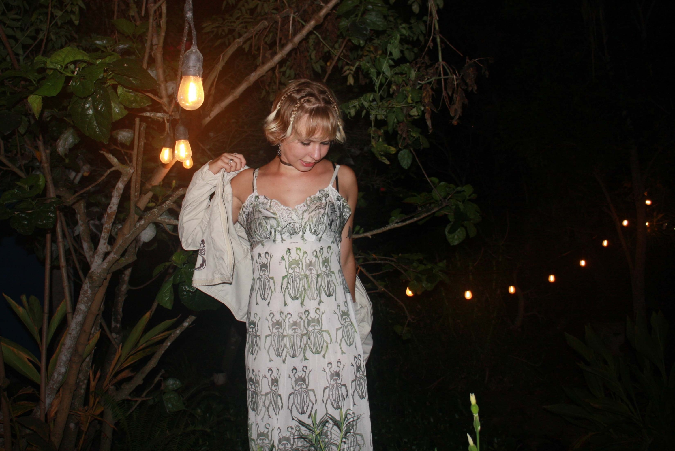 woman with blond hair and dress with bug prints