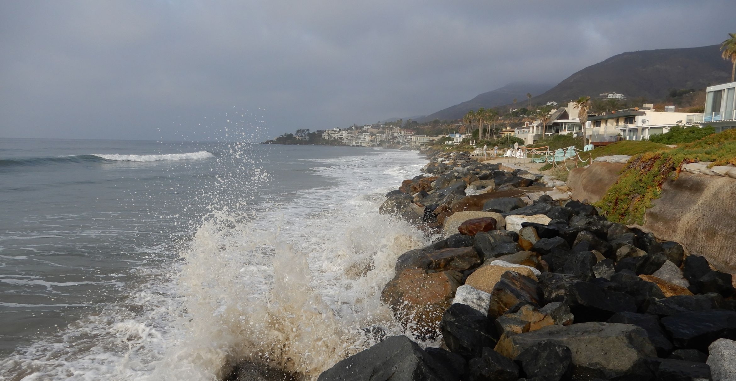 Waves crash on a revetment protecting houses along Broad Beach, Malibu.