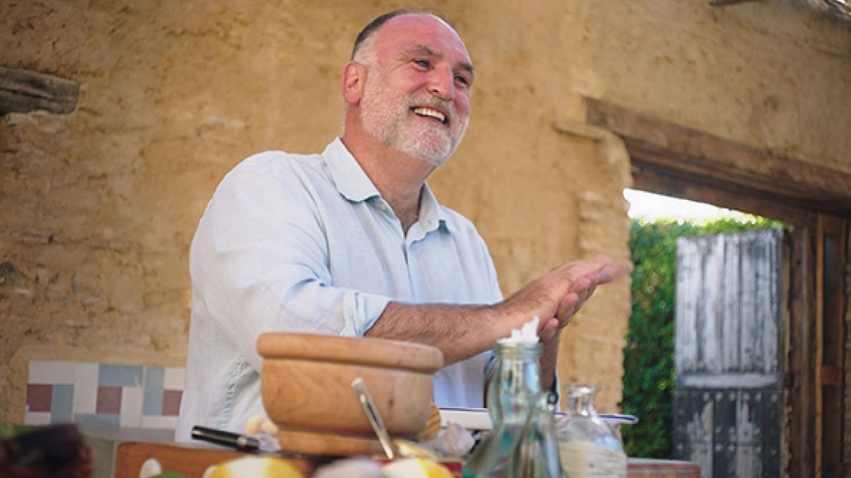 white man with grey beard preparing food