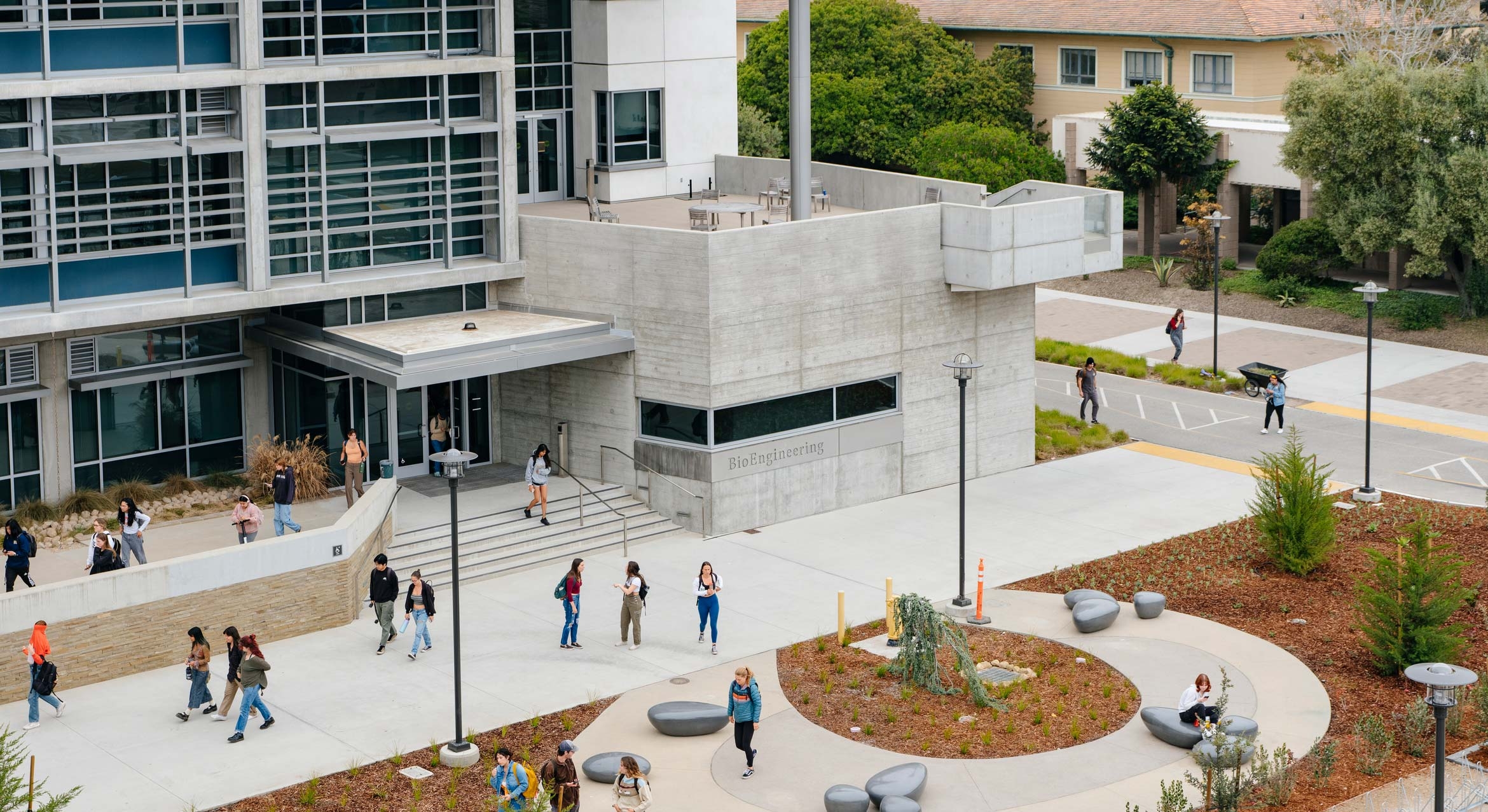 A diverse mix of college students in motion outside a university building