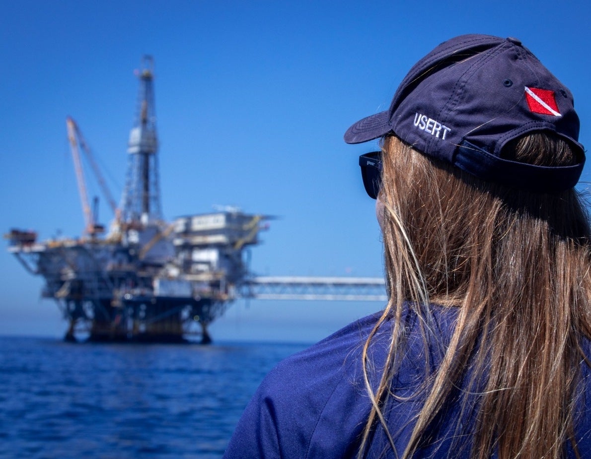 a diver looking at an offshore oil platform